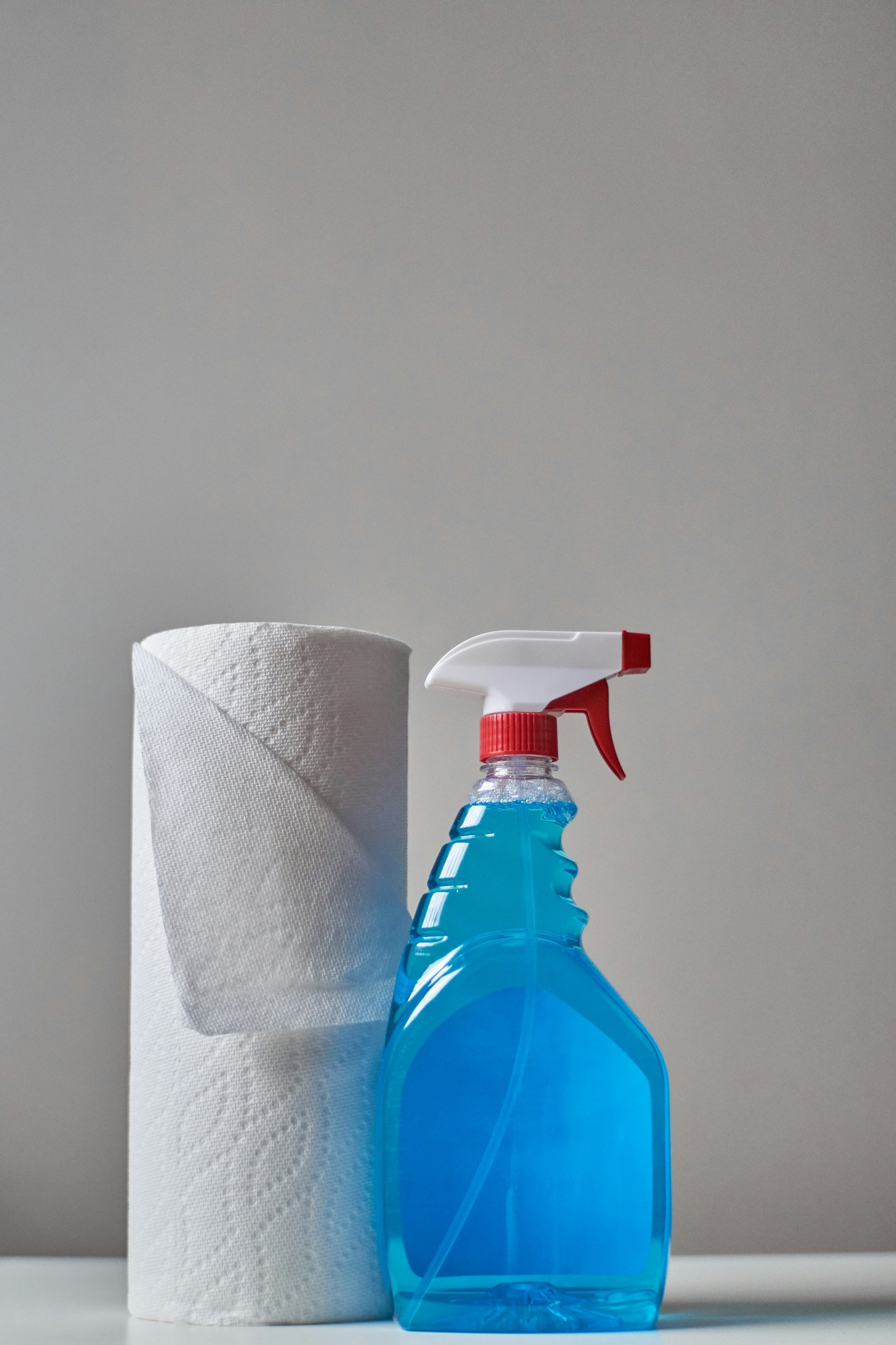 Clear spray bottle on neutral background